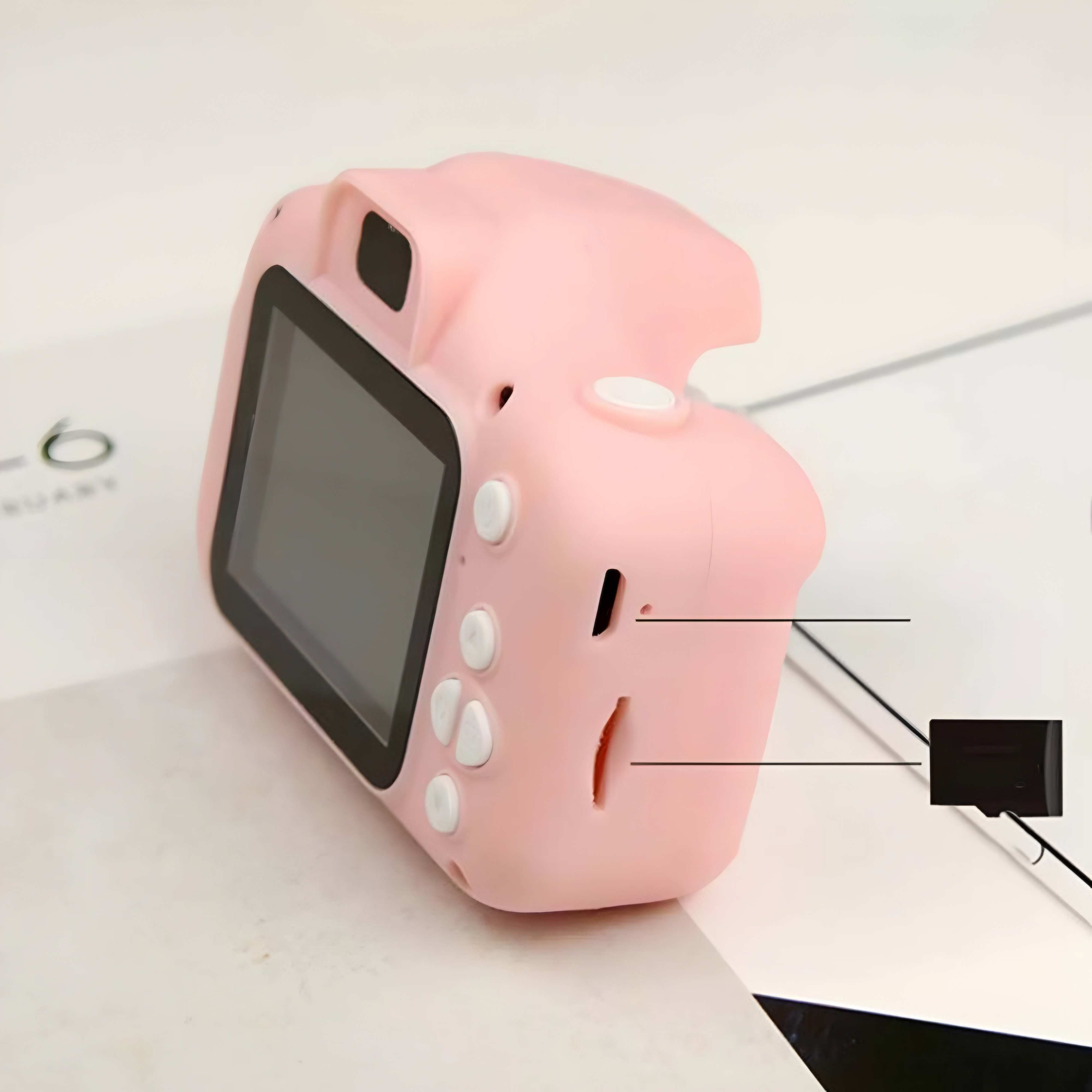 Pink toy camera with screen and buttons on a light background