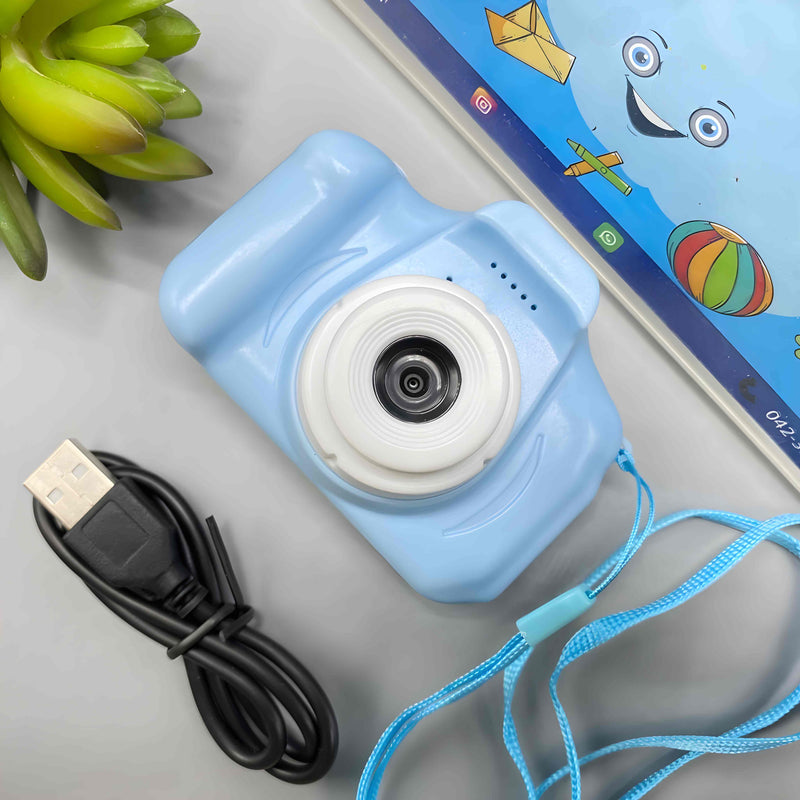 Blue toy camera with USB cable and packaging on a light surface