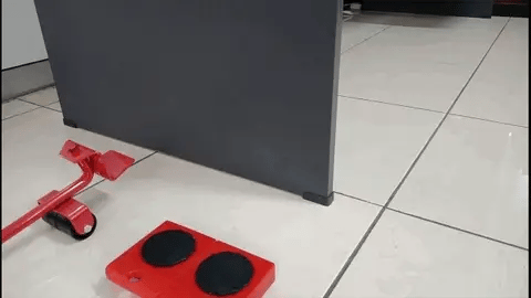 Real demonstration of the furniture lifting lever and four roller pads lifting and repositioning a cabinet